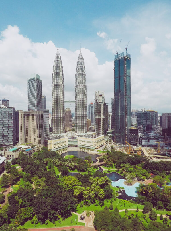 petronas-twin-towers-near-skyscrapers-trees-blue-sky-kuala-lumpur-malaysia (1)